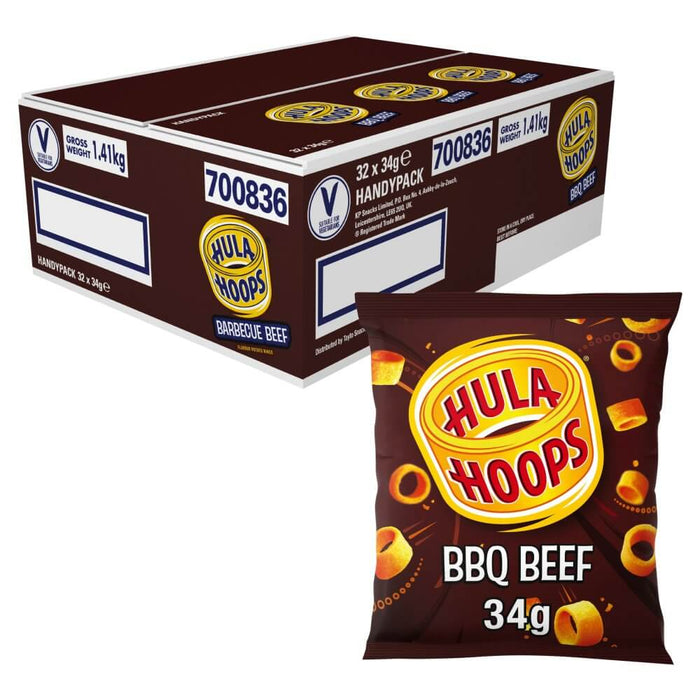 A case of Hula Hoops BBQ Beef 32 x 34g packs, with one packet in front. The dark brown packaging features Hula Hoops branding in yellow and red alongside images of the signature ring-shaped crisps.