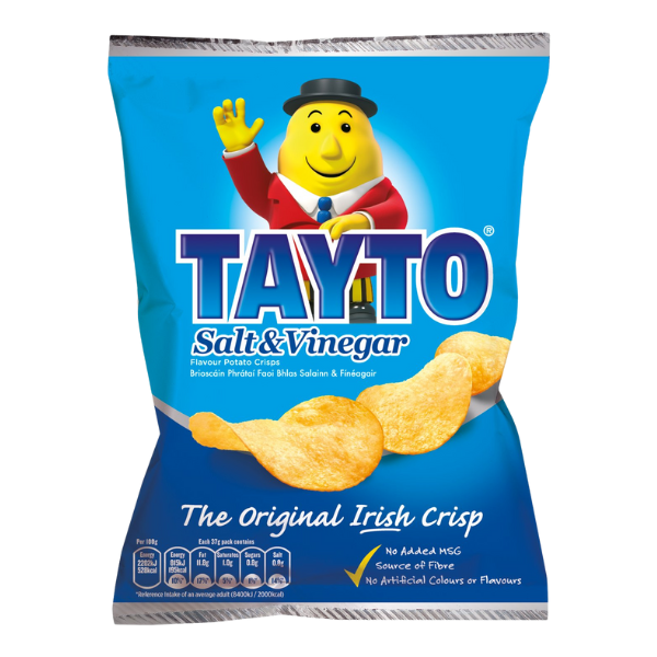 Blue bag of Tayto Salt & Vinegar crisps featuring a smiling cartoon mascot in a suit. Tagline reads: "The Original Irish Crisp."