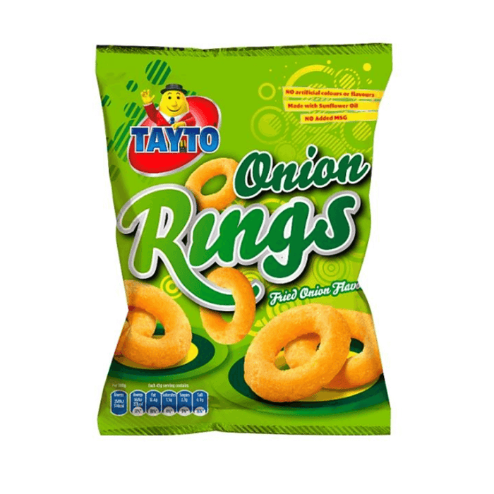 A box of 32 Tayto Large Onion Rings (40g) features green packaging with the Tayto logo, smiling mascot, yellow onion rings images, and highlights bold fried onion flavour and no added MSG.