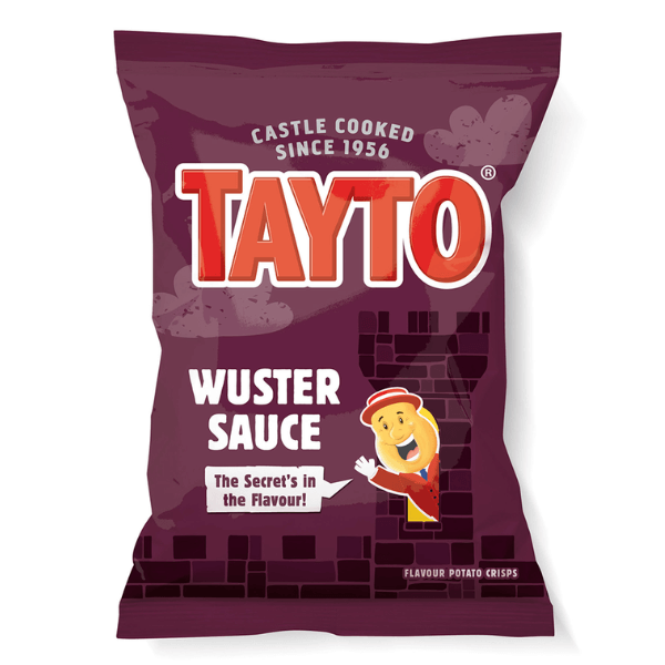 A box of 32 Tayto Northern Ireland Wuster Sauce Flavour Potato Crisps (32.5g each) with bold red and white branding, a purple background, and the cartoon mascot tipping his hat beside the slogan The Secret’s in the Flavour!.