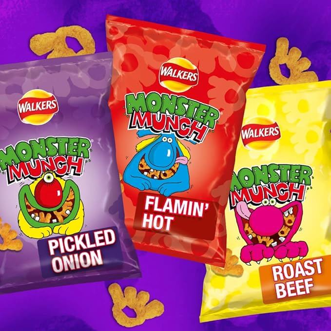 Three packets of Walkers Monster Munch snacks on a purple background