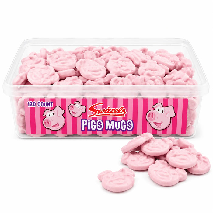 A clear plastic tub filled with pink pig-shaped gumdrops or candy, with a few pieces spilled in front. The front label reads "Swizzels" and "Pigs Mugs" with a pink striped design and cartoon pig faces.