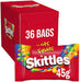A red box of Skittles Fruits candy next to a single 45g packet, with '36 BAGS' printed on the box.