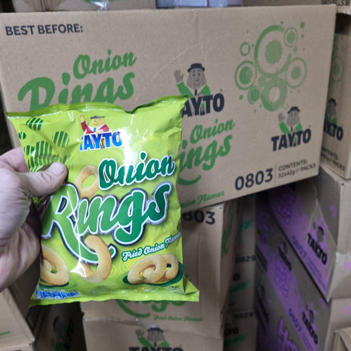 Bright green bag of Tayto Onion Rings with a cartoon character logo, featuring fried onion-flavored snacks and no added MSG.